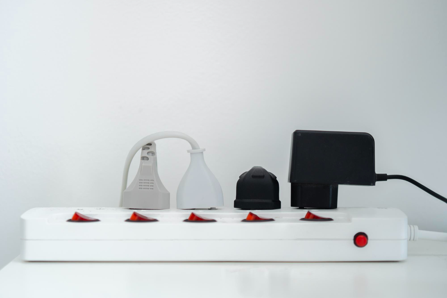 A group of organized cables under a clean desk.