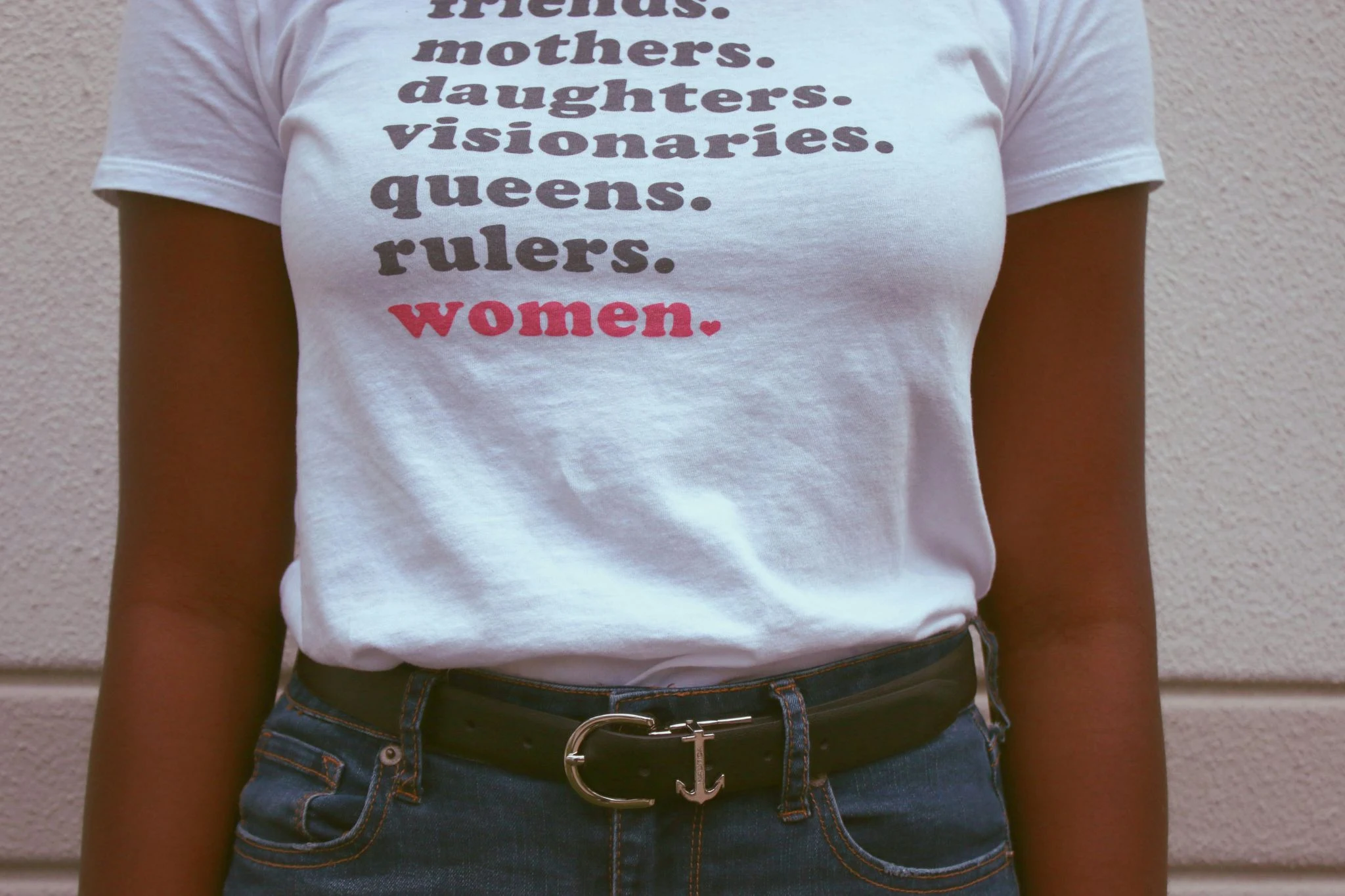 women standing confidently wearing shirt that says strong women mothers daughters