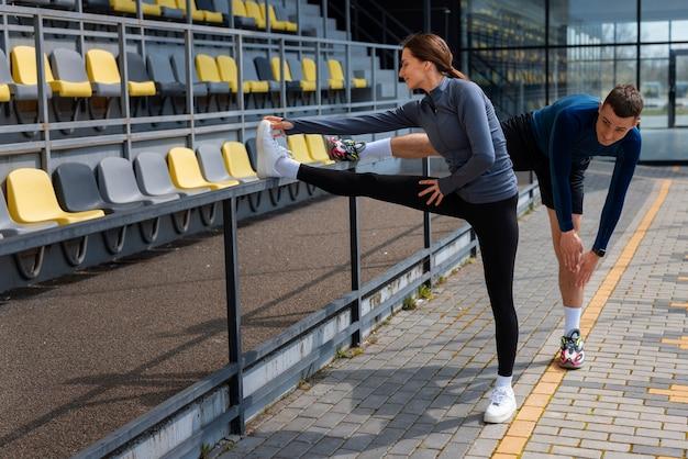 Full shot couple doing workout exercises