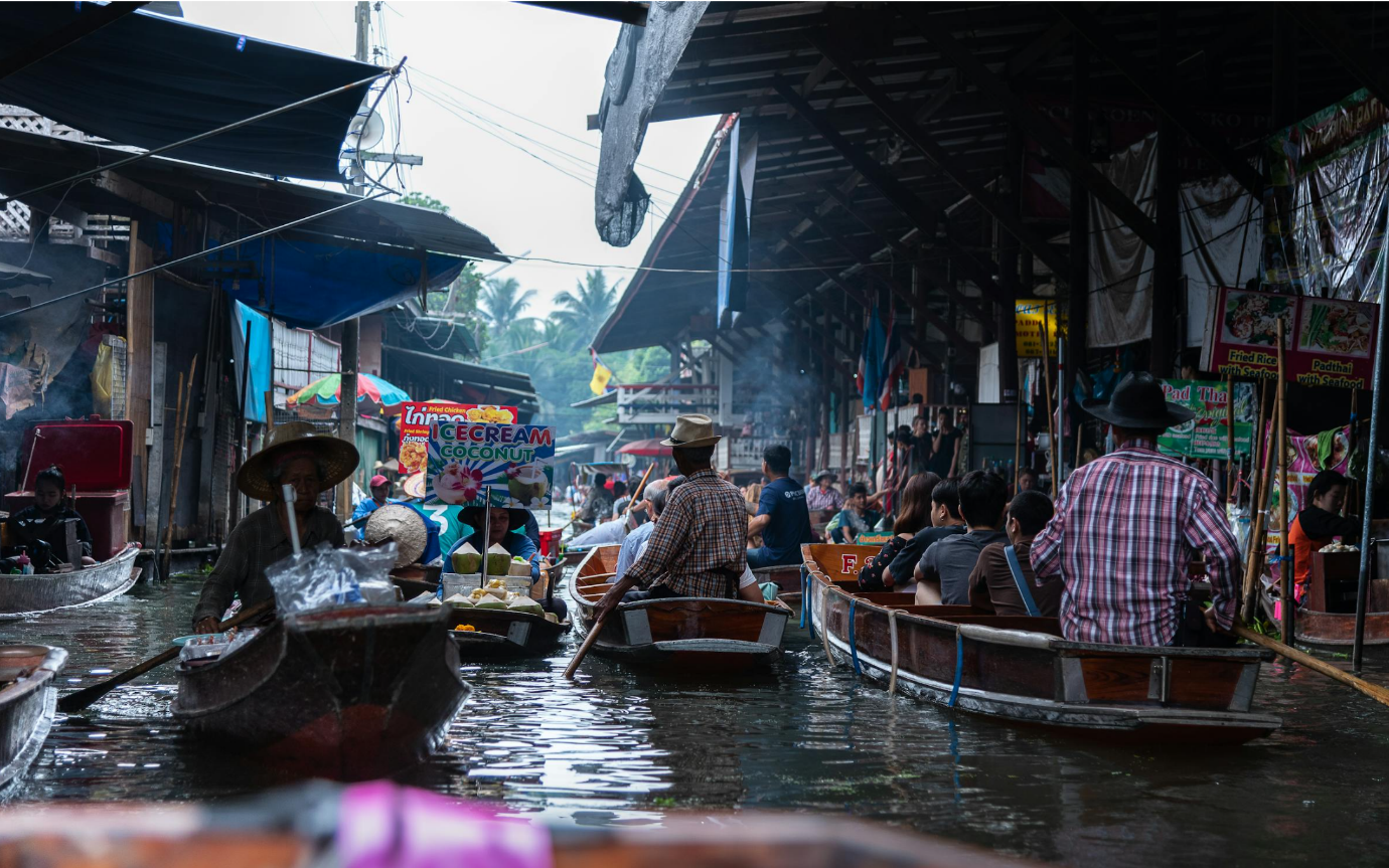 A group of people in boats in a canal

Description automatically generated