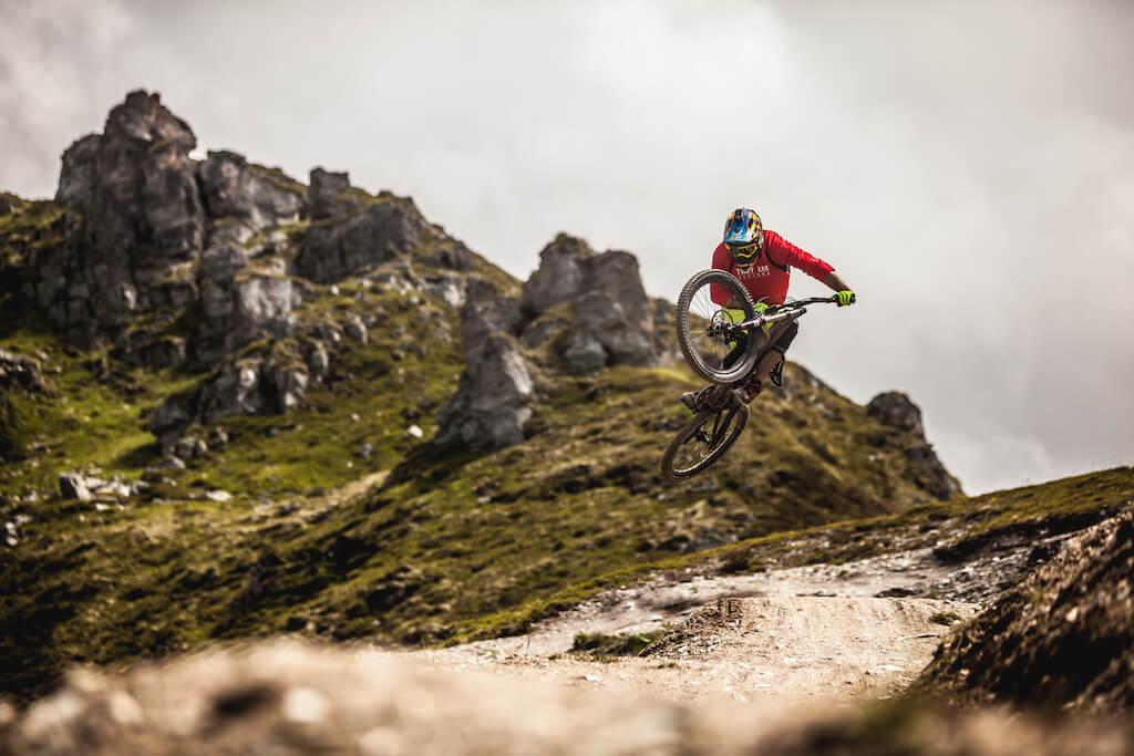 Man jumping with bike on a mountain