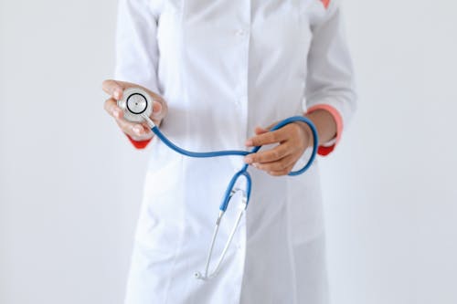 Free Person Holding a Blue and Silver Stethoscope Stock Photo