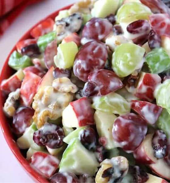 Waldorf salad with grapes and apples in a red bowl