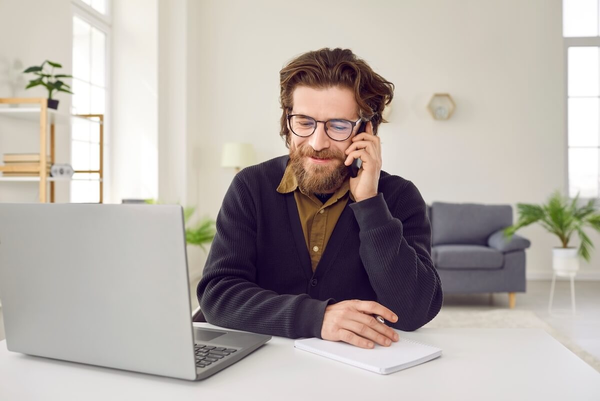 Leave of absence policy: employee wearing a pair of eyeglasses talking on the phone