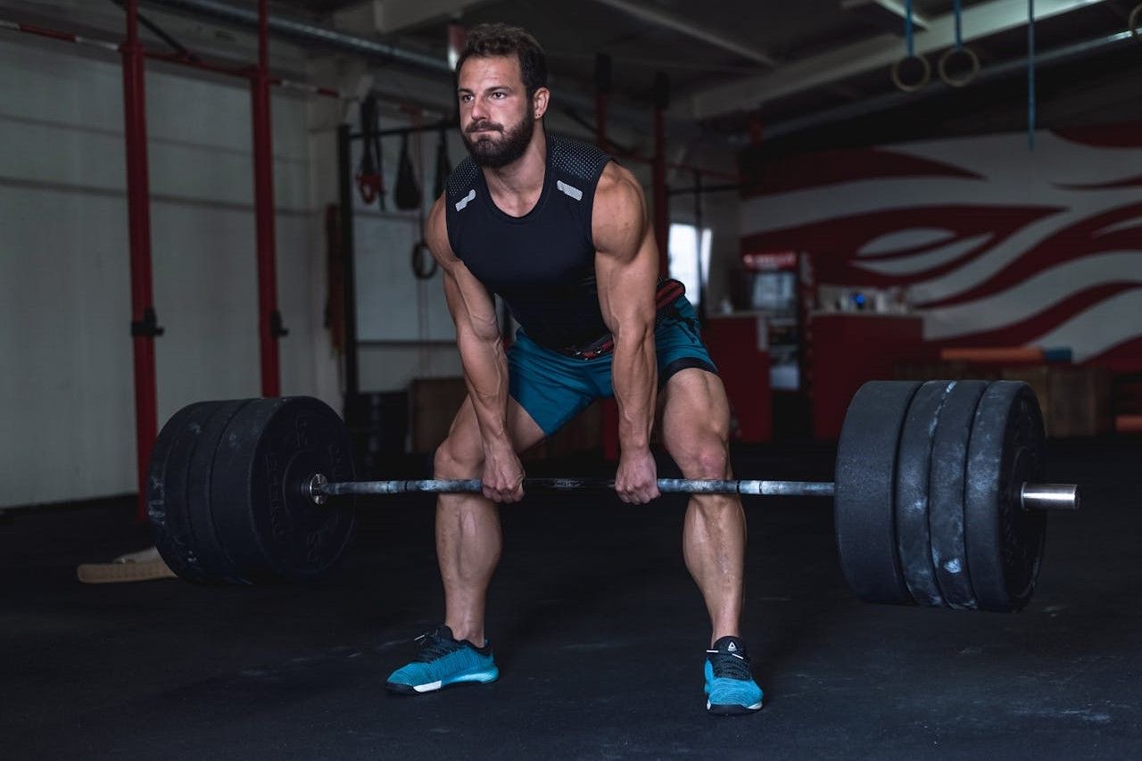 An athlete executing a heavy deadlift in a modern gym.