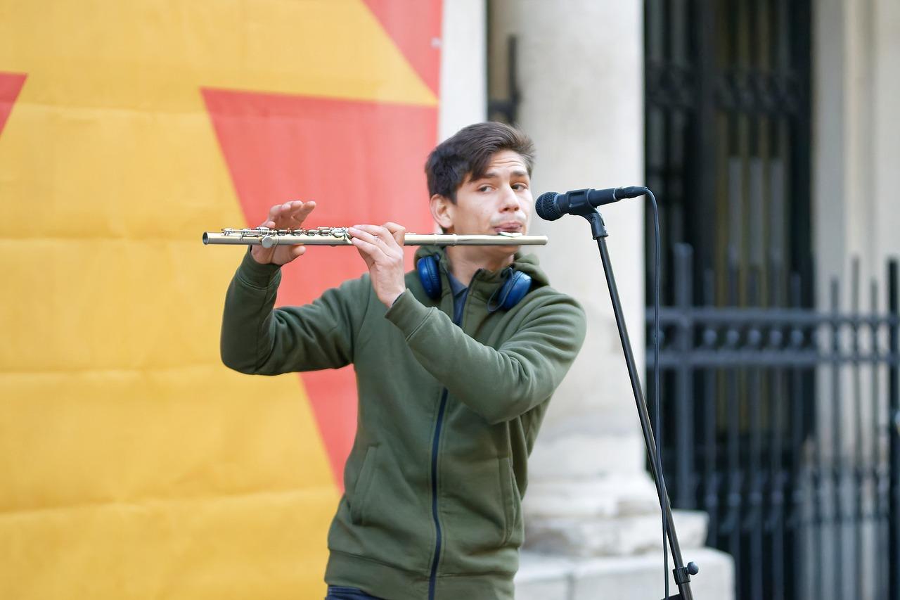 A person playing a flute

Description automatically generated