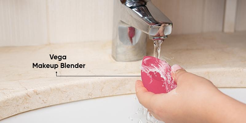 A hand washing a pink soap under a faucet

Description automatically generated