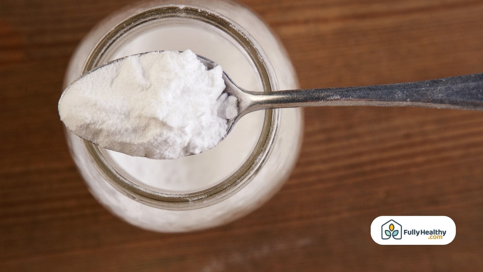 Spoonful of baking soda above jar
