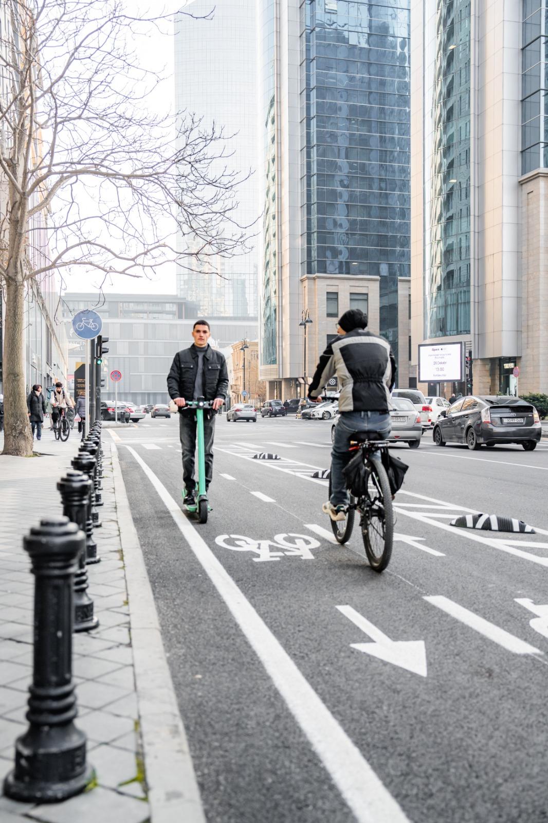 Two men riding bicycles on a street

AI-generated content may be incorrect.