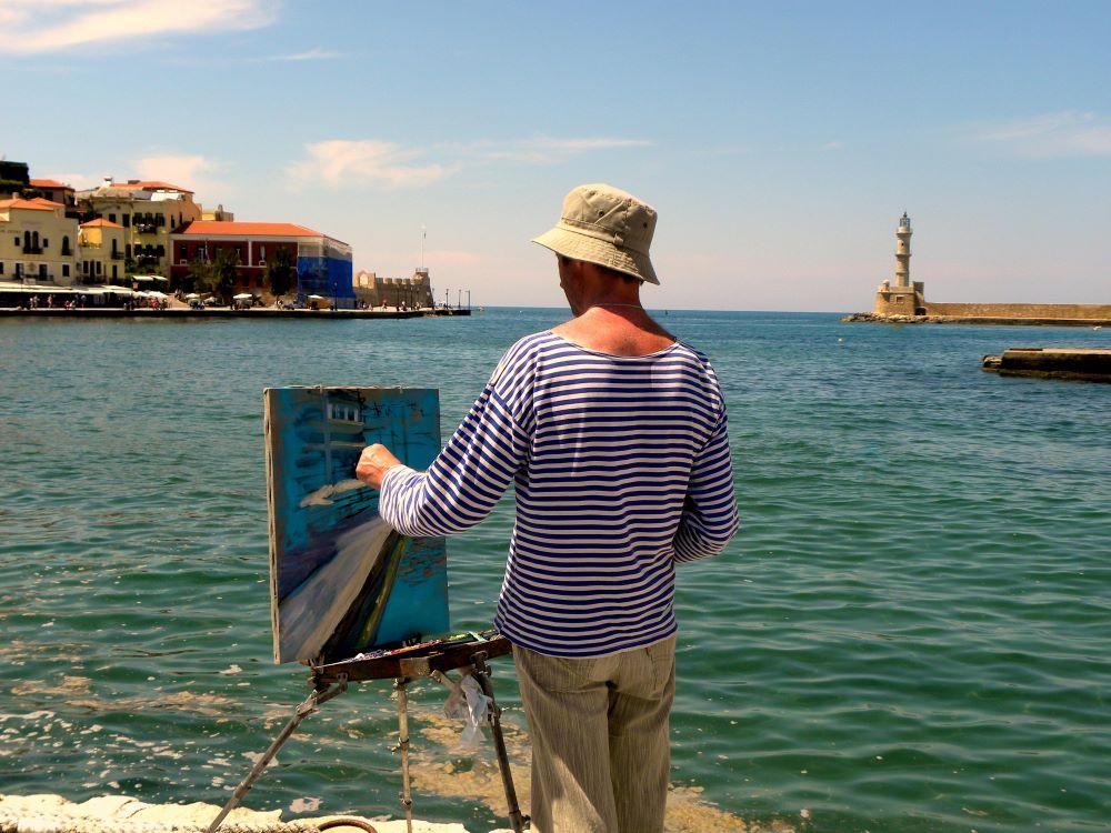 A man painting the sea coast