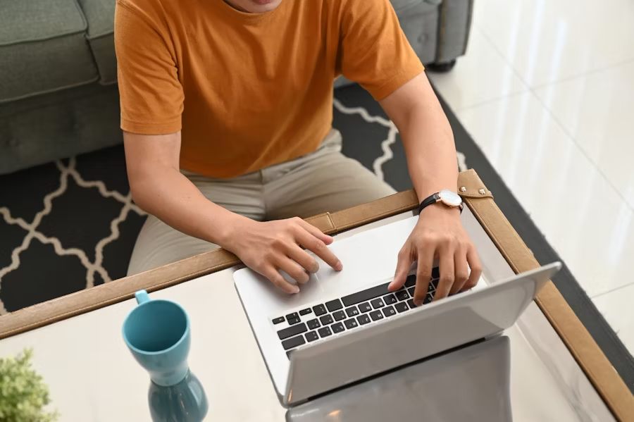 Blogger typing on a laptop at home, demonstrating why blogging still works in 2025 as a powerful digital content strategy.