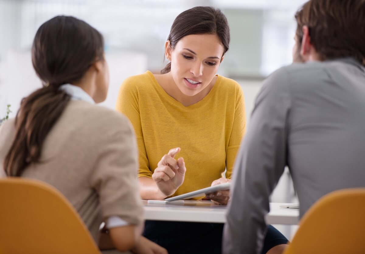 Employee benefits management: HR manager talking to 2 employees