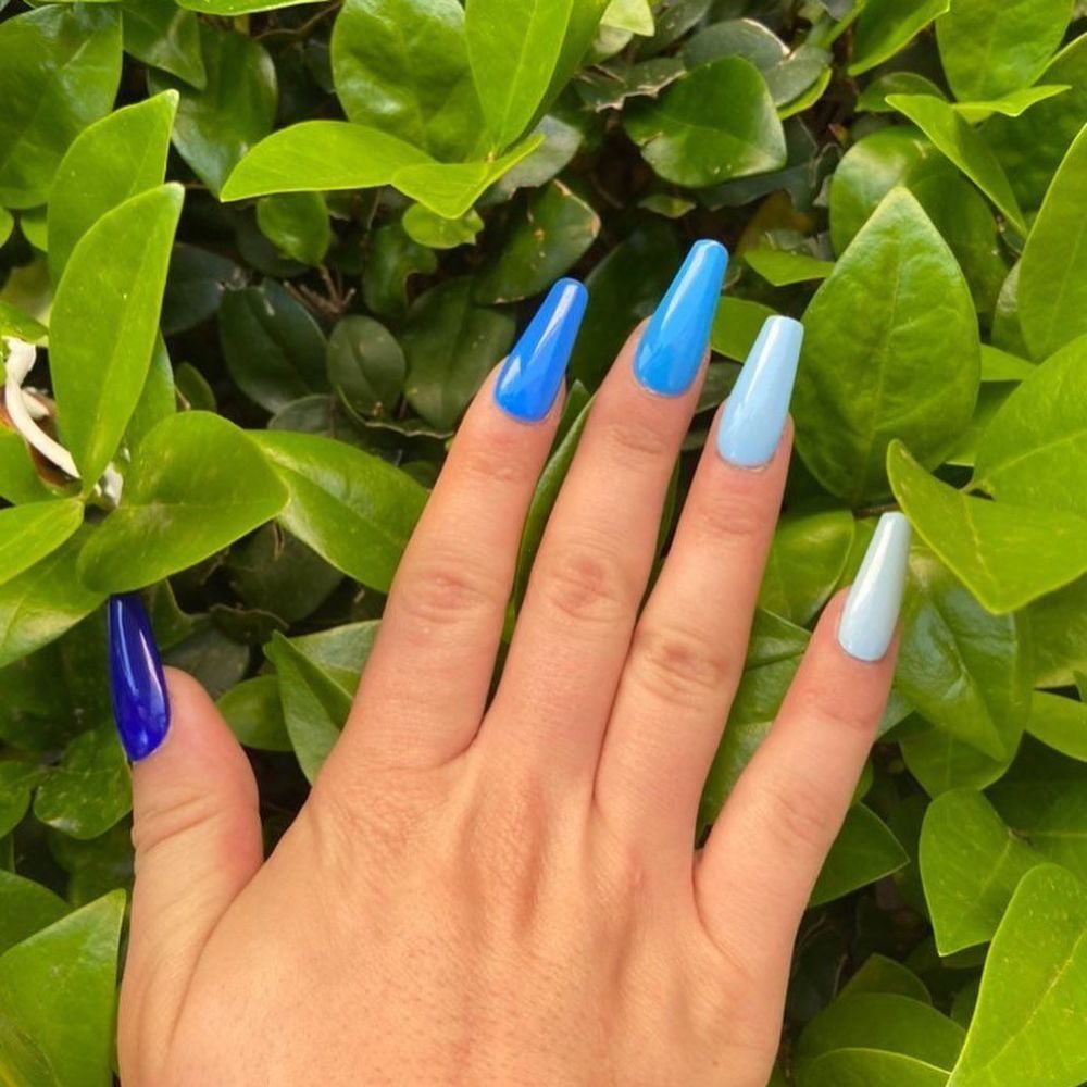 Close up of hands with blue winter nails having Cute Colors of winter