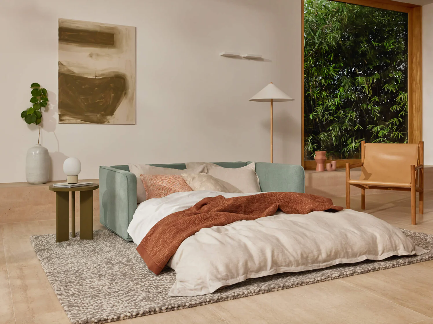 fold-out sleeper sofa with duvet and pillows