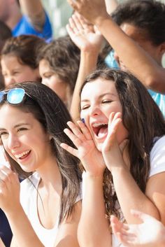 This is an image of xcited crowd of fans cheering 