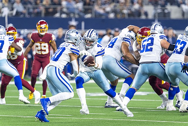 Washington Commanders and Dallas Cowboys football teams facing off during a game.