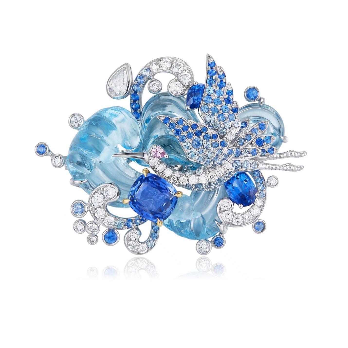 A blue and white brooch with diamonds and a bird

Description automatically generated