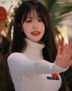 A picture of Wonyoung on a white turtle neck wool dress 