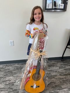 Kennedy holding a prize