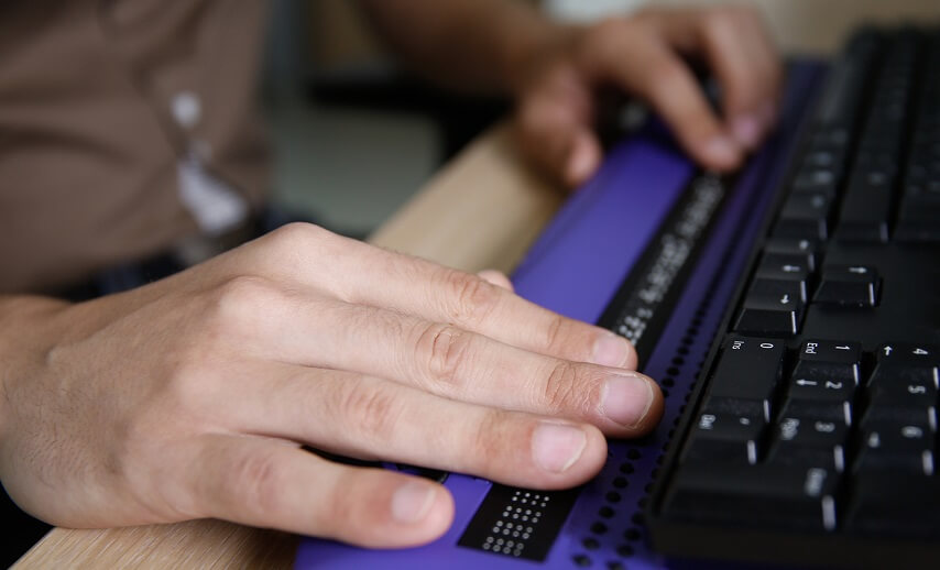 A close-up of a keyboard for blind people with customizable key settings, offering programmable functions