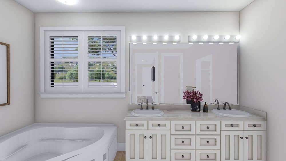 Primary bathroom with a deep soaking tub and a dual sink vanity topped with a frameless mirror.