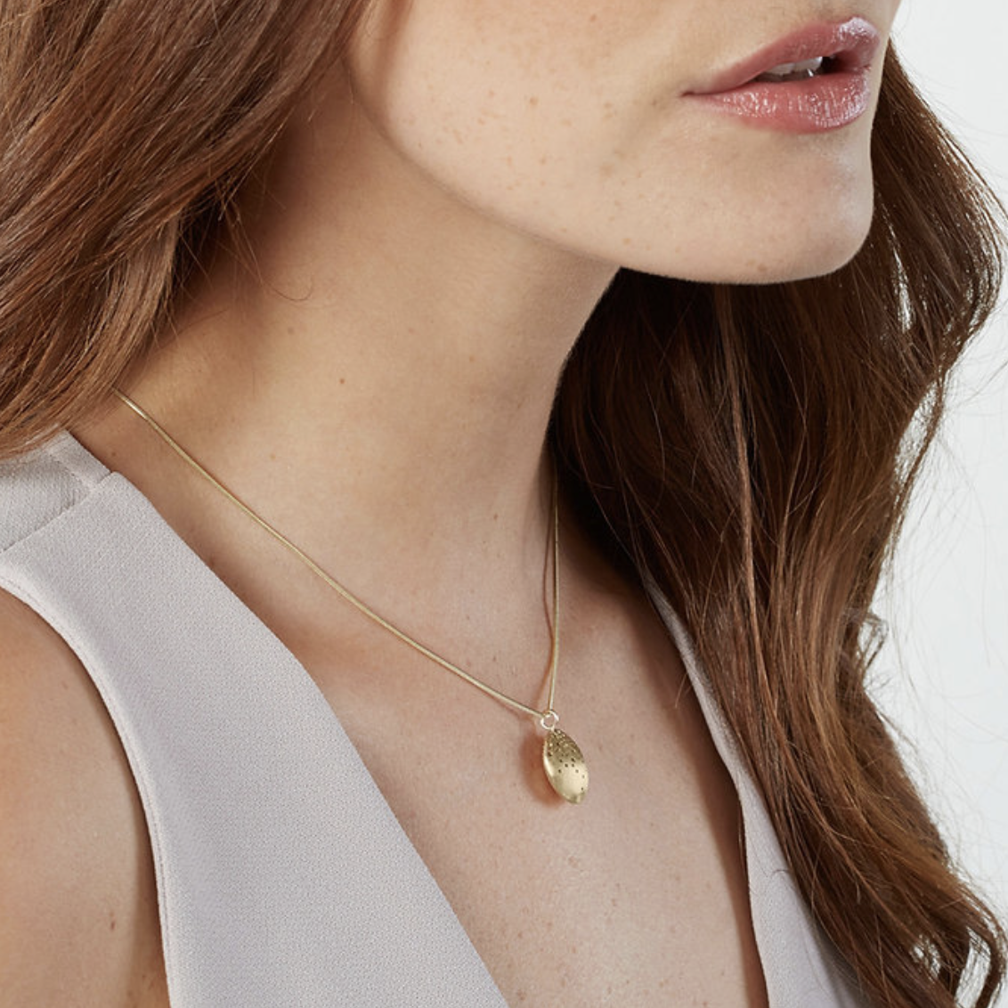 patterned gold pod necklace