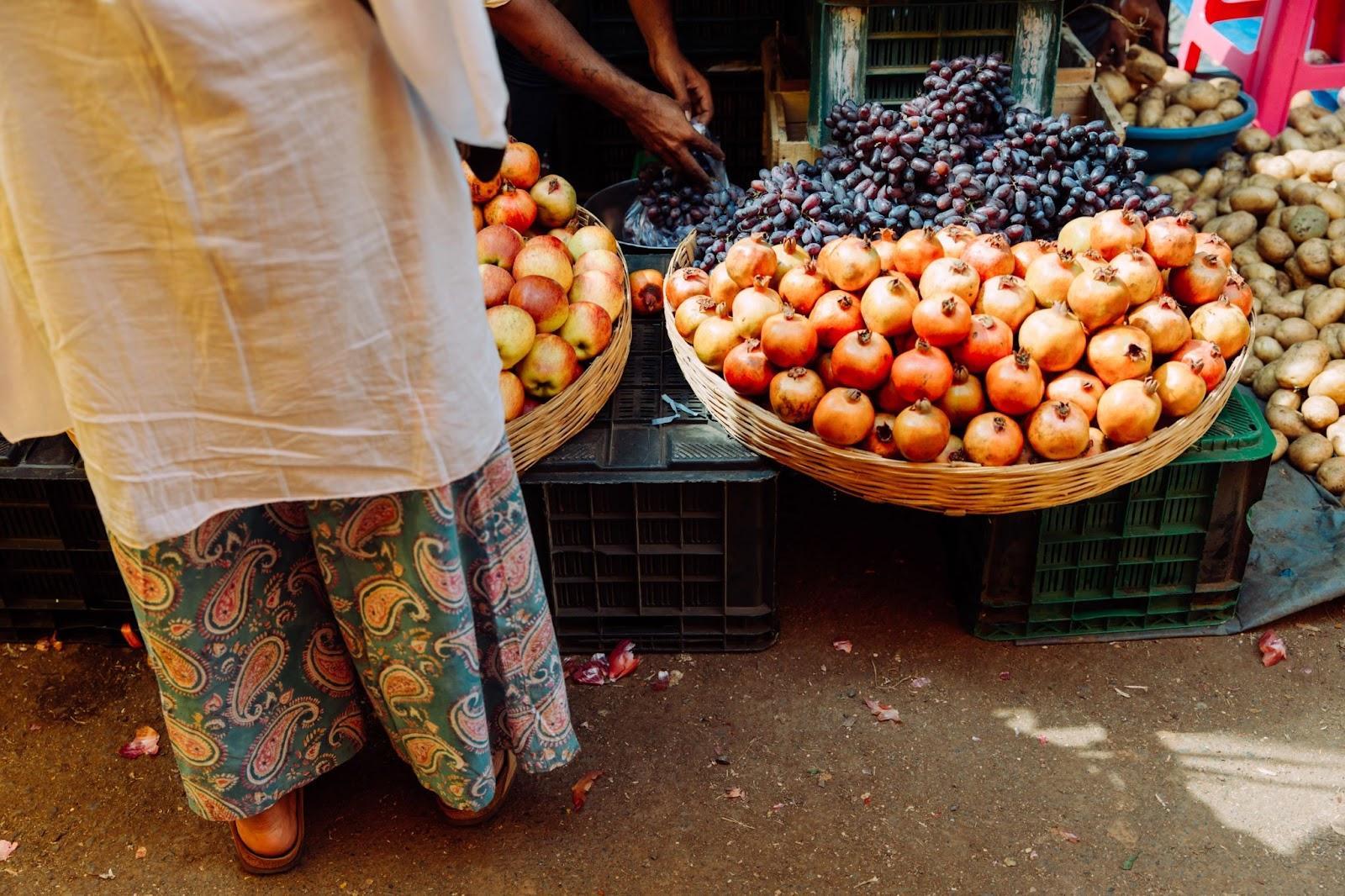 Indian lady buying fruits at market