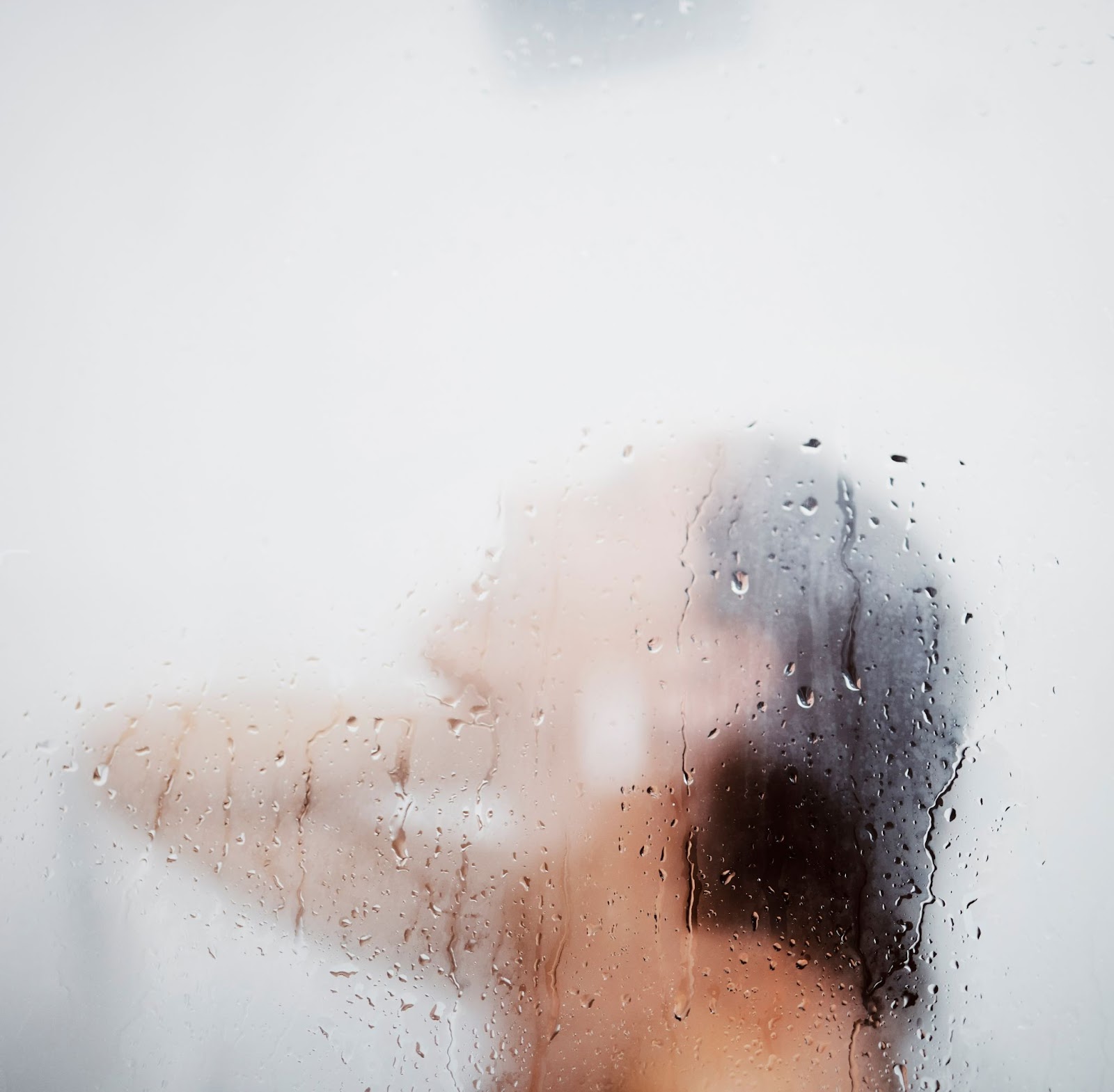 Woman in a hot shower not adhering to proper Microneedling aftercare