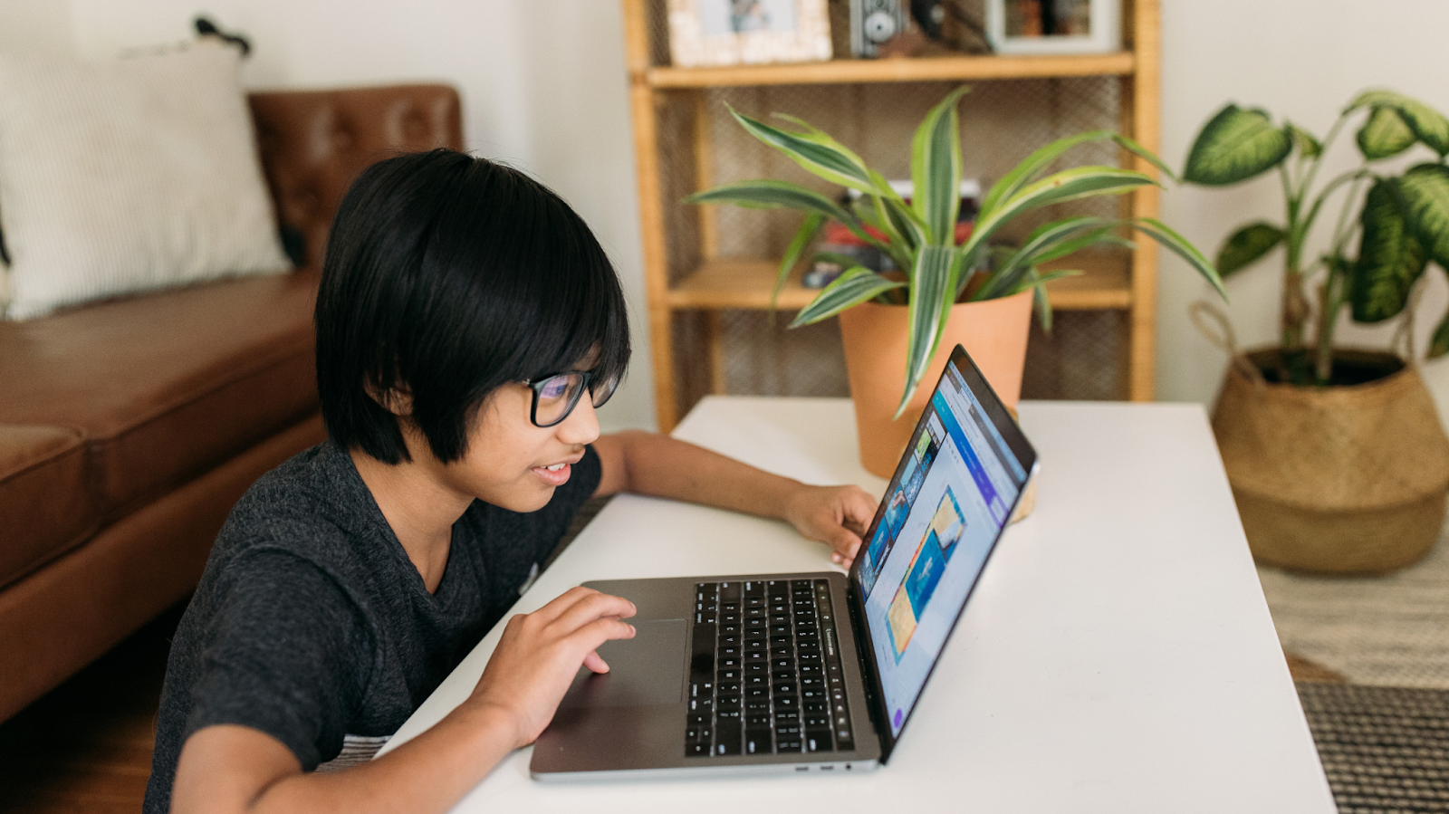child focusing on computer 