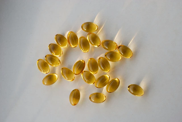 Close-up of golden cod liver oil capsules, rich in omega-3 and essential nutrients