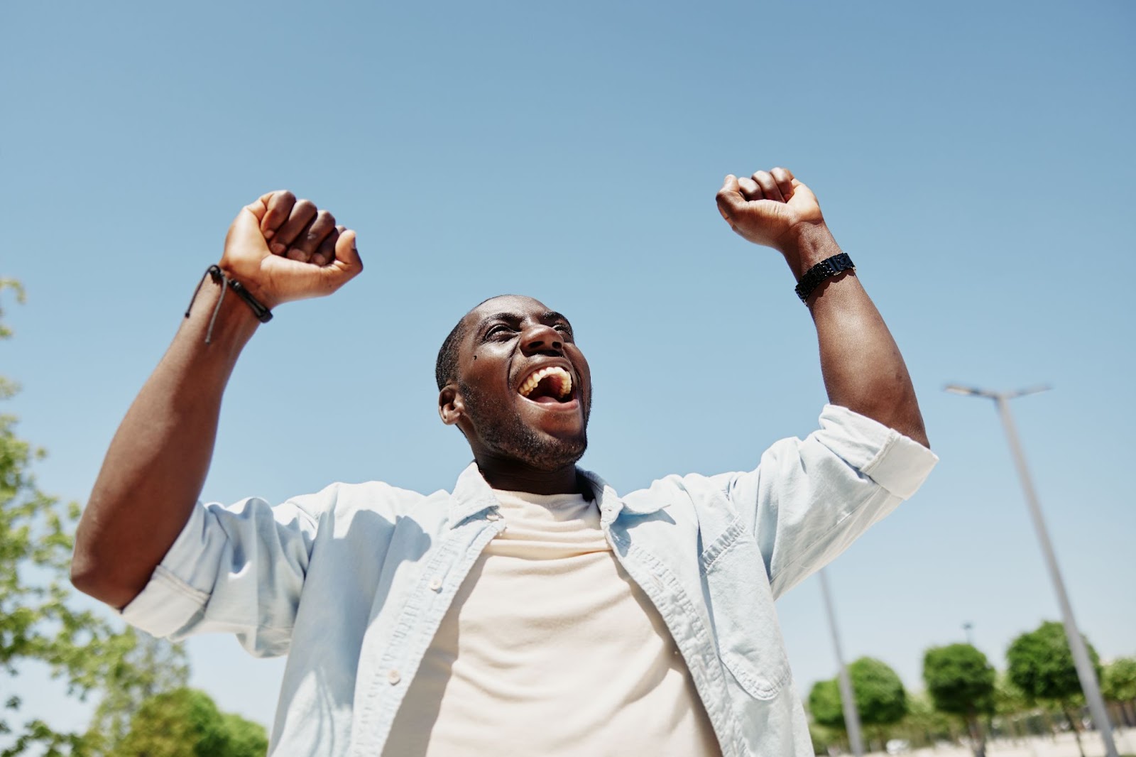 Man who is happy with his hands up cheering