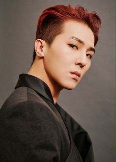 This contains an image of WINNER's Mino with red hair wearing a black shirt