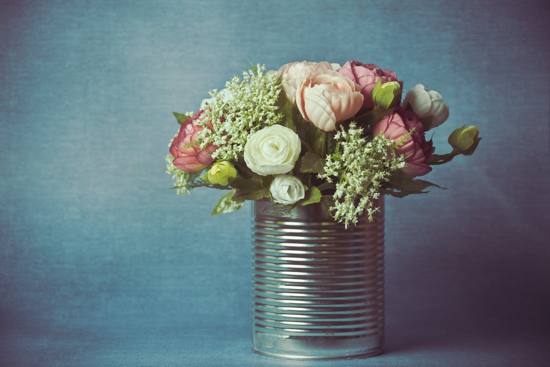 tin can with flowers placed inside