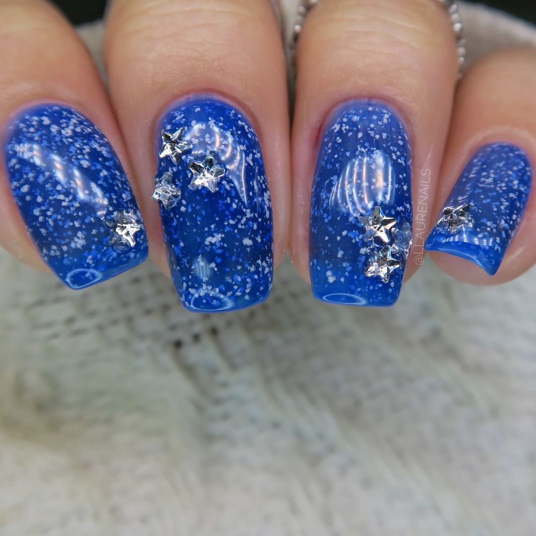 Close up of hands with blue winter nails having Winter Magic