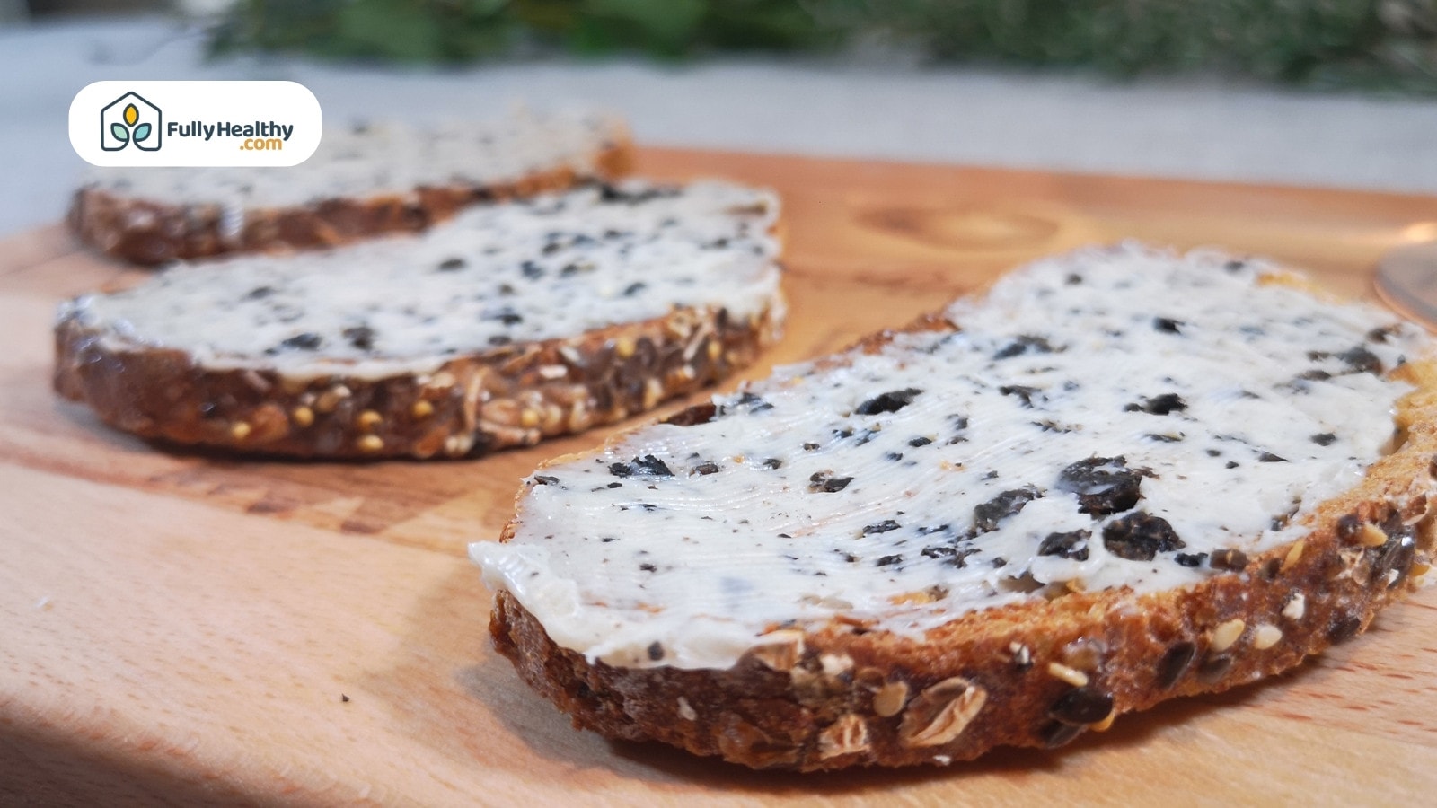 Whole grain bread slices spread with creamy black truffle butter