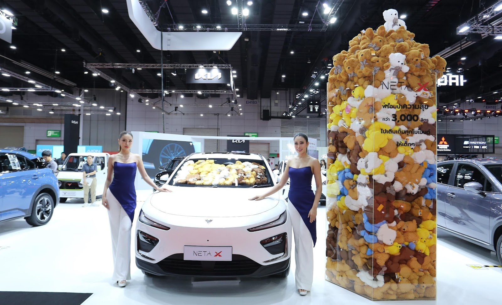 Two women standing next to a car

Description automatically generated