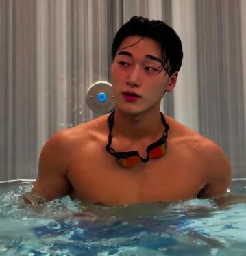 This contains an image of ATEEZ's San in a swimming pool