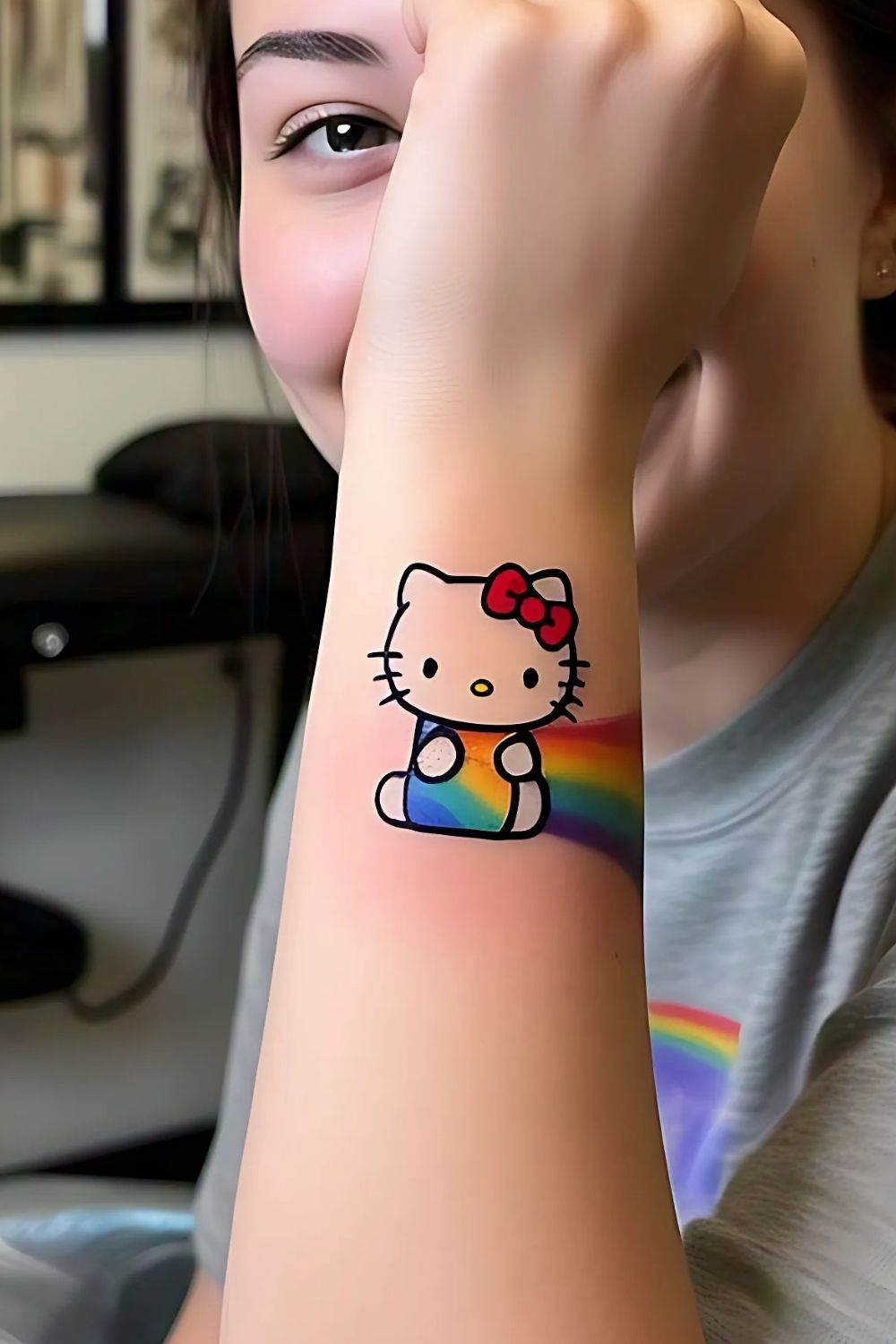 Hello Kitty Under a Rainbow Tattoo