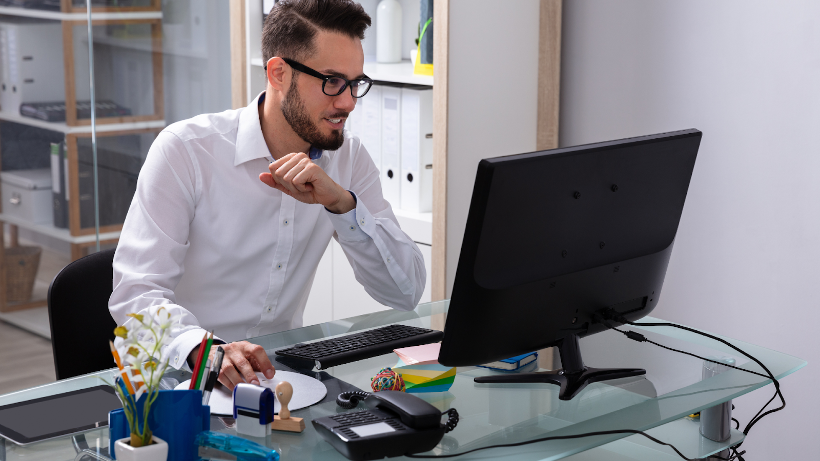 Employee is happy because he has made his computer work