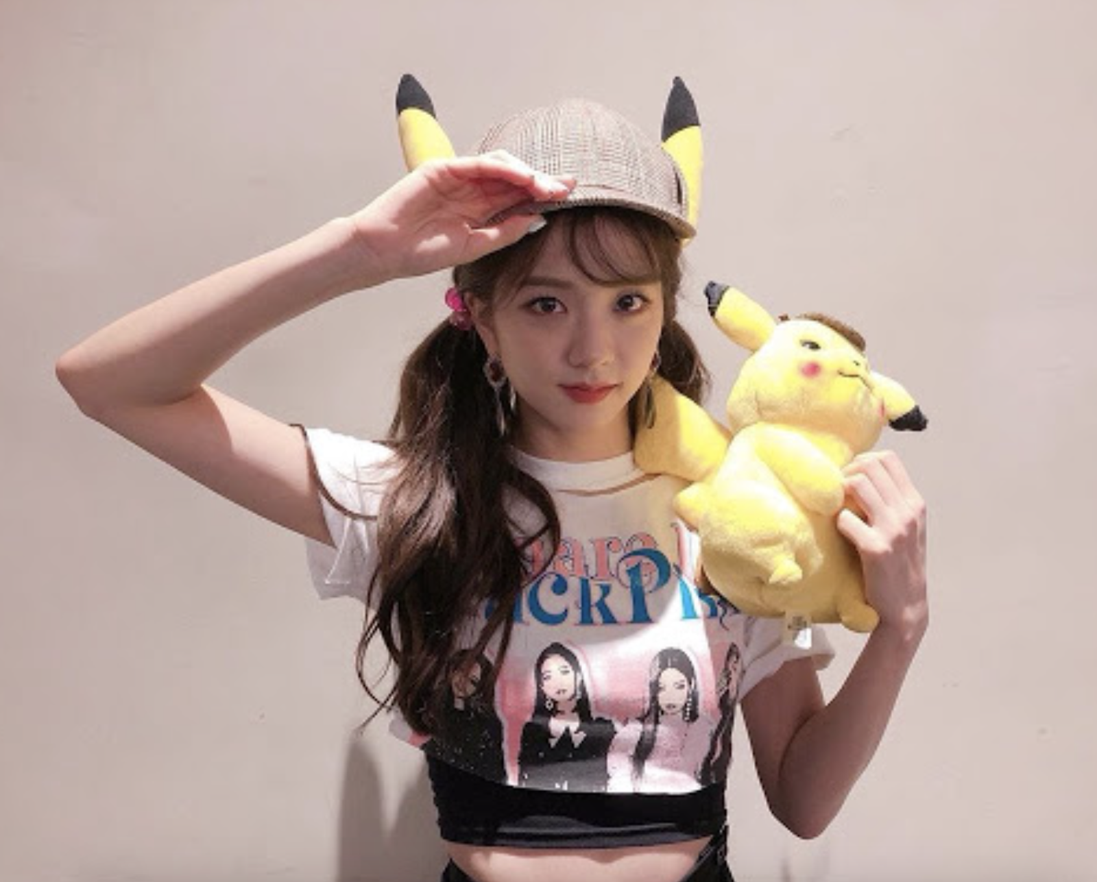 A picture of Jisoo wearing a white shirt holding a teddy bee on her hand 