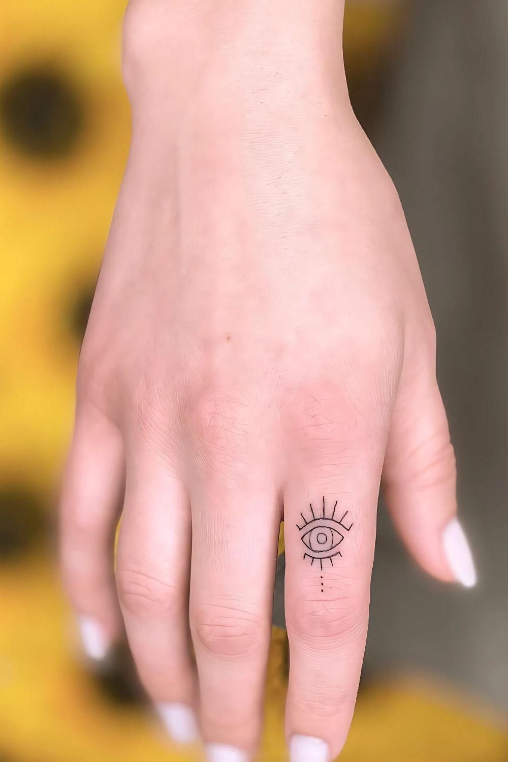 Evil Eye Finger Tattoo