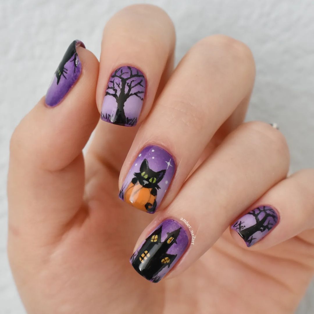 Close-up of Halloween-themed nails with detailed designs like haunted house, black cat, tree with bat, and pumpkin.