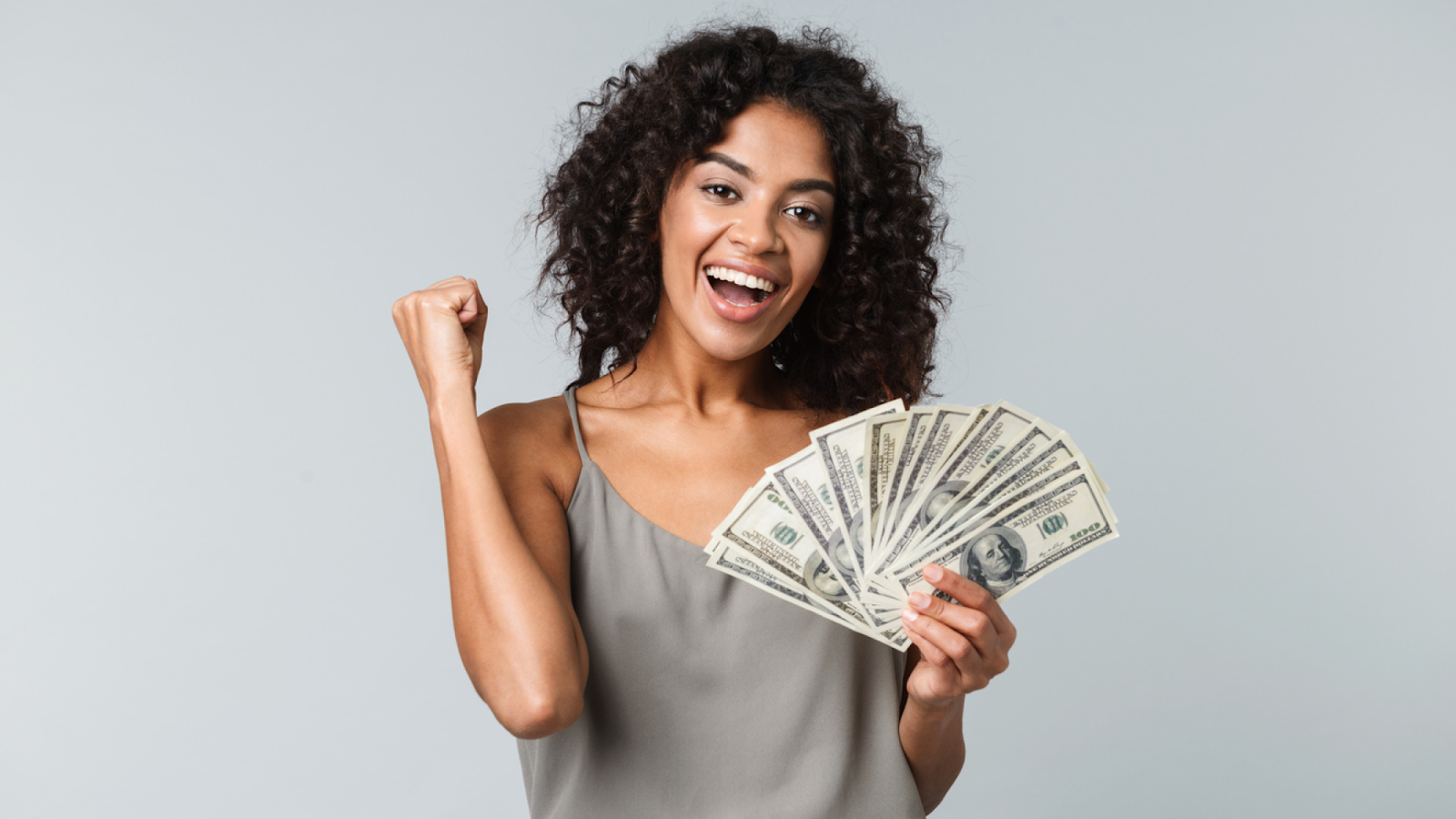 young happy woman holding cash