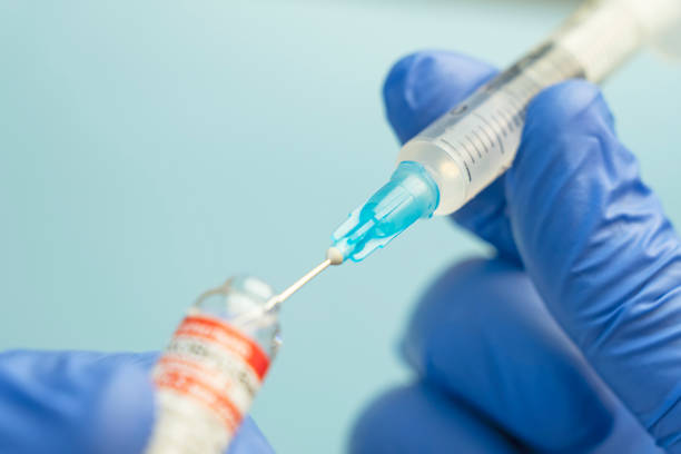 a-gloved-hand-holding-a-syringe-drawing-liquid-from-a-vaccine-vial-on-a-light-blue-background-what-big-pharma-wont-say-vesilute-rebuils-your-blood-vessels-at-the-genetic-level-tony-huge
