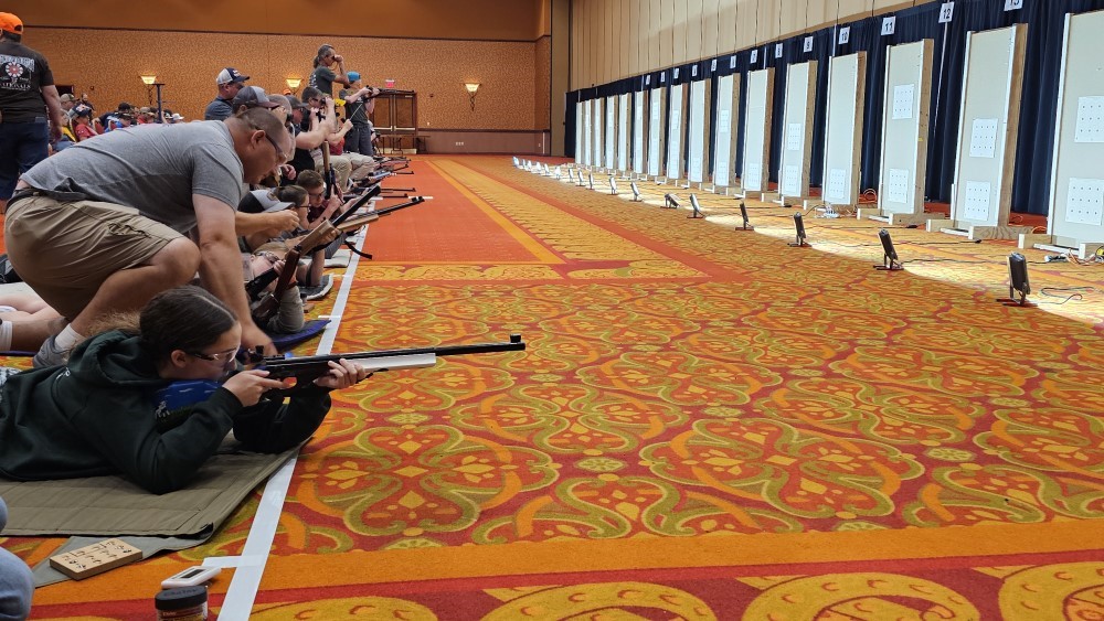 Line of contestants in the prone position take their shots in the hope of glory. 