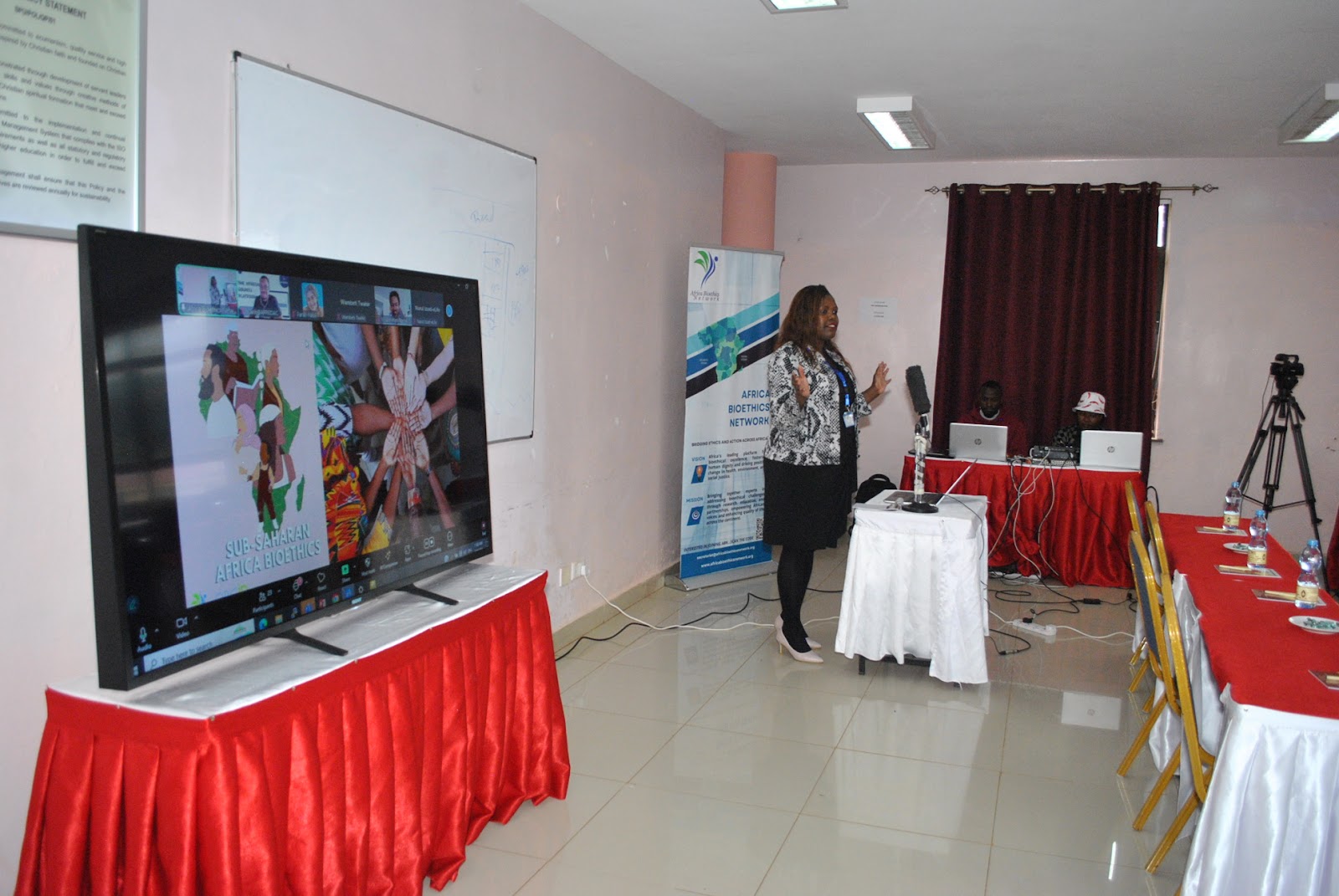 Mercury Shitindo behind a microphone and a visual display next to her. Caption: Mercury Shitindo, Executive Director of the Africa Bioethics Network, introduces the vision behind the ORCID Bioethics CoP and its integration into ABN’s research and mentoring infrastructure.