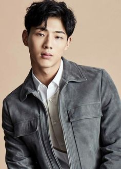 This is a picture of Kim Ji Soo wearing a shirt and an ash colour jacket