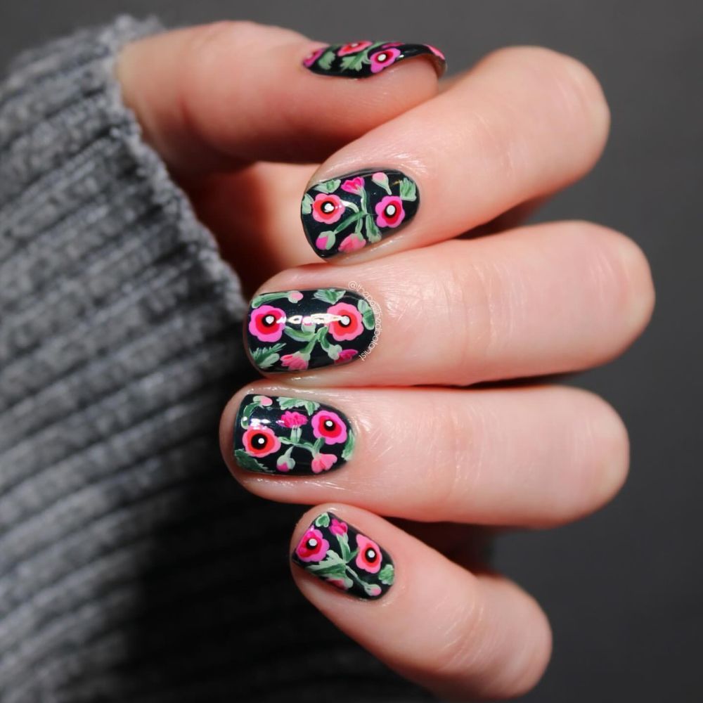 Close up of flowered short nail design with Red and Black Floral Nail Art