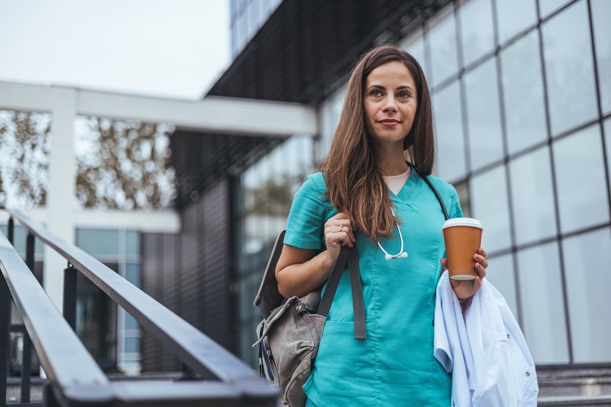 FMLA Oregon: doctor holding a cup of coffee while walking