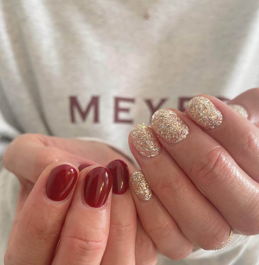 Festive Christmas nail designs featuring red and green nails with glitter accents, snowflakes, and holiday-themed nail art.